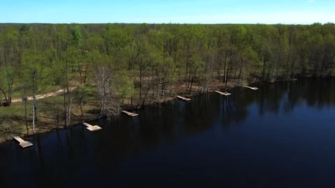 View of the lake from above. Early spring. Fishing lake with fishing platforms Stock Footage 274413957
