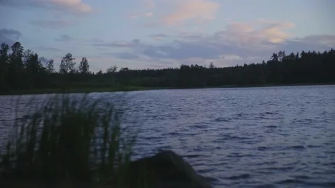 View of the lake after sunset. The wind raises small waves. Stock-Footage 230011233