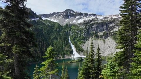 View of Lake Ann and mountain peaks framed by pine trees Stock Footage 342076334
