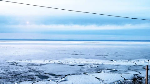 View of lake Baikal on a spring day. Frozen ice on the lake. Video stock 112370950