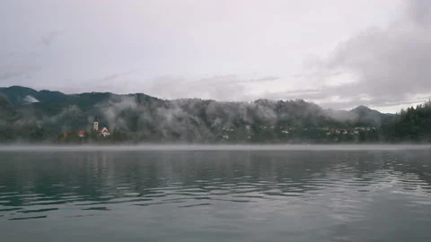 View of lake Bled and Bled island under fog and mist in early morning, Bled Stock-Footage 148011000
