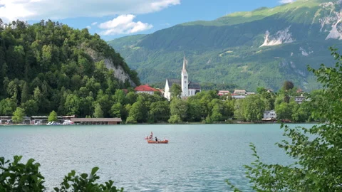 View of Lake Bled in Slovenia with unrecognizable people rowing a boat 스톡 동영상 341422731