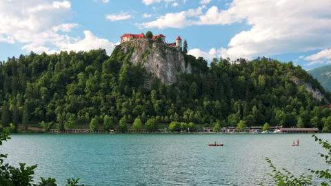 View of Lake Bled in Slovenia with unrecognizable people rowing boats 스톡 동영상 341422740