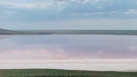 View lake clouds pink water mountains shore Stock Footage 219376331
