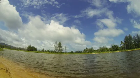 View of lake with clouds running through blue sky. Speed up. Stock Footage 42560740