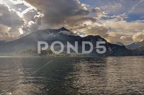 View of Lake Como in a cloudy day with sunshine in Bellagio Stock Photos