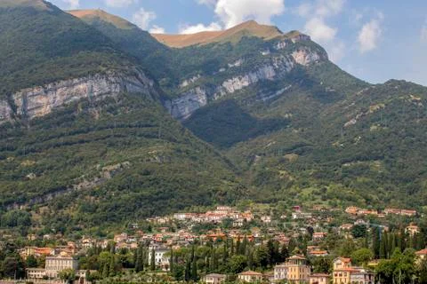 View from Lake Como to a small town at the foot of the hills. Stock Photos