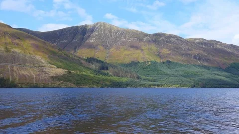 View of the lake at the foot of the mountains. Stock Footage 80043455