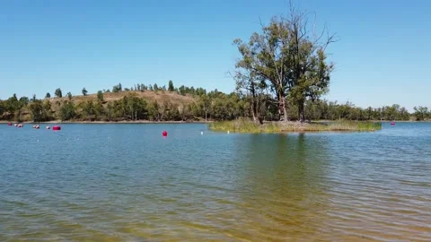 View from a lake with isle with trees in background Stock Footage 134977572