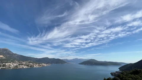 View of a lake with mountains and clouds creating a stunning natural landscape Vídeo Stock 282229862