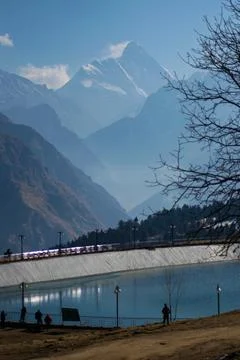 View of lake with nanda devi peak on a bright sunny day in Uttarakhand Stock Photos