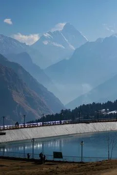 View of lake with nanda devi peak on a bright sunny day in Uttarakhand Stock Photos