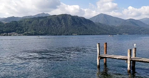 View of Lake Orta (Lago d'Orta) with boats and ducks in Piedmont, Italy Stock Footage 128403380
