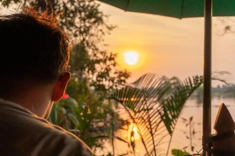 View on a lake at sunset with a guy in the foreground in Angkor wat, in Cam.. Stock Photos