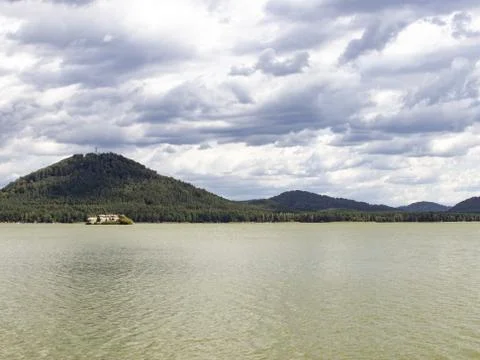 View of the lake surface, hills, clouds in windy weather Stock Photos