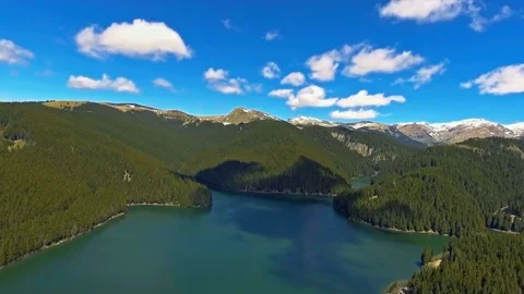 View from the lakeside at the foothills of the Bucegi mountain range Video stock 75935847