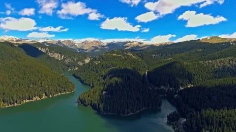 View from the lakeside at the foothills of the Bucegi mountain range 스톡 동영상 75935956