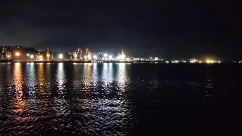 View of the land and its lights seen from the sea at night Stock Footage 292465184