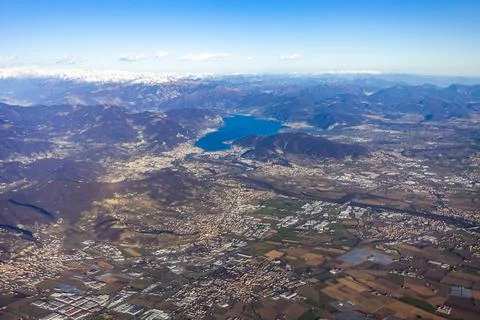 View of the land surface from a window of the plane flying at big height Stock Photos