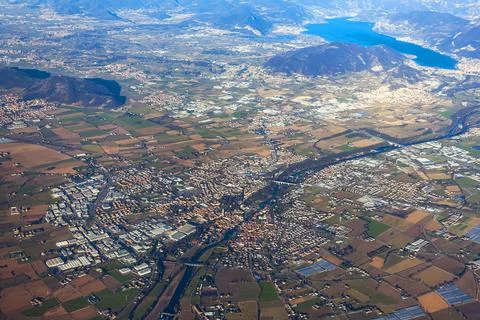 View of the land surface from a window of the plane flying at big height Stock Photos