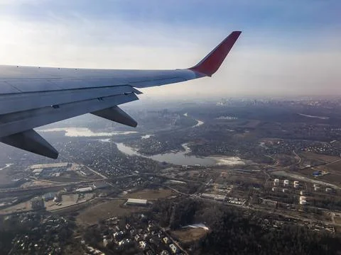 View of the land surface from a window of the plane flying at big height, Moscow Stock Photos