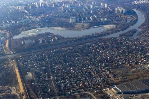 View of the land surface from a window of the plane flying at big height, Moscow Stock Photos