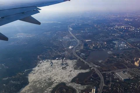 View of the land surface from a window of the plane flying at big height, Moscow Stock Photos