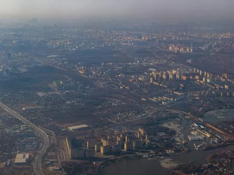 View of the land surface from a window of the plane flying at big height, Moscow Stock Photos
