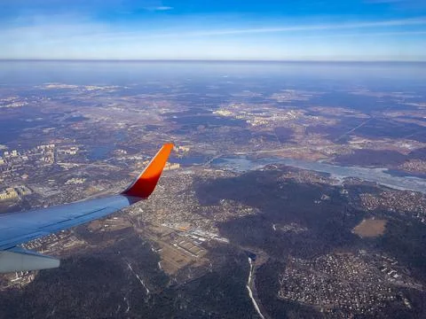 View of the land surface from a window of the plane flying at big height, Moscow Stock Photos
