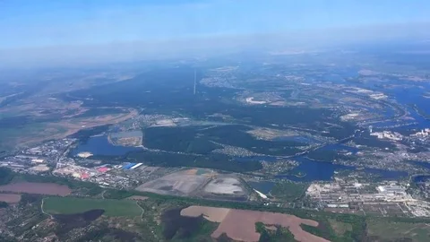 View on landscape of fields and river from window of flying plane Stock Footage