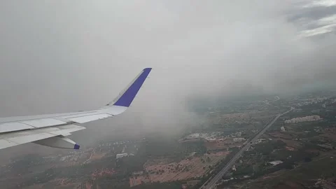 View of landscape while airplane moving through clouds, FullHD 1080p Stock Footage 138679995