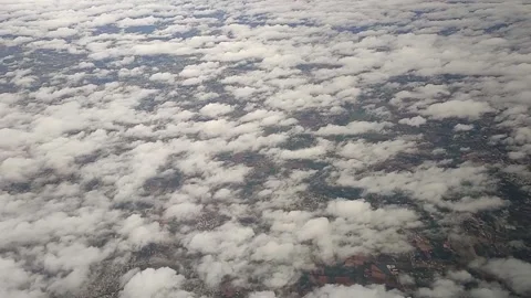 View of landscape while airplane moving through clouds, FullHD 1080p Stock Footage 138680584