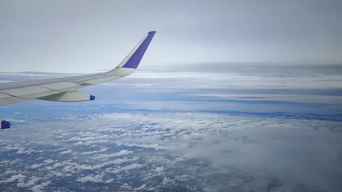View of landscape while airplane moving through clouds, FullHD 1080p Stock Footage 138680937