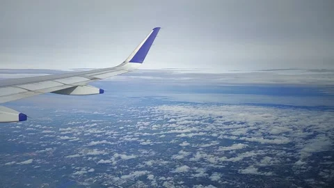 View of landscape while airplane moving through clouds, FullHD 1080p Stock Footage 138681054
