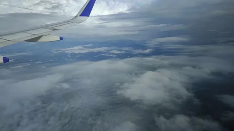 View of landscape while airplane moving through clouds, FullHD 1080p Stock Footage 138683333