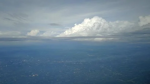 View of landscape while airplane moving through clouds, FullHD 1080p Stock Footage 138683924