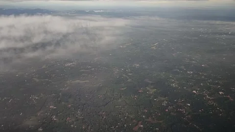 View of landscape while airplane moving through clouds, FullHD 1080p Stock Footage 138684053