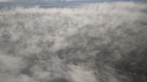 View of landscape while airplane moving through clouds, FullHD 1080p Stock Footage 138684174