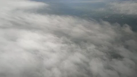 View of landscape while airplane moving through clouds, FullHD 1080p Stock Footage 138684248