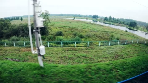 View to a landscape from the window of the moving train. Summer countryside. Stock Footage 160594283