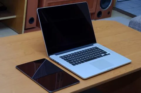 View on a laptop pc and a tablet on a desk in a home office Stock Photos
