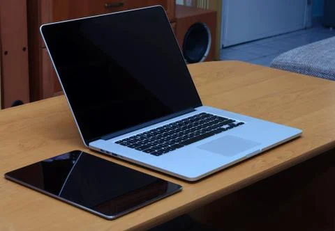 View on a laptop pc and a tablet on a desk in a home office Stock Photos