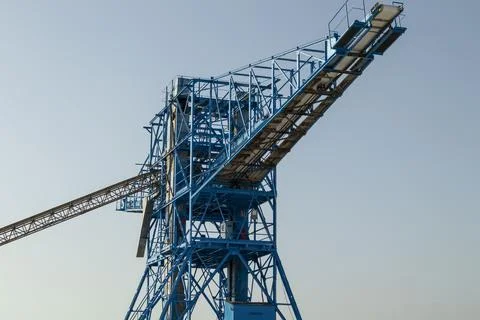 View of a large blue crane and conveyor belt structure used in salt mining .. Stock Photos