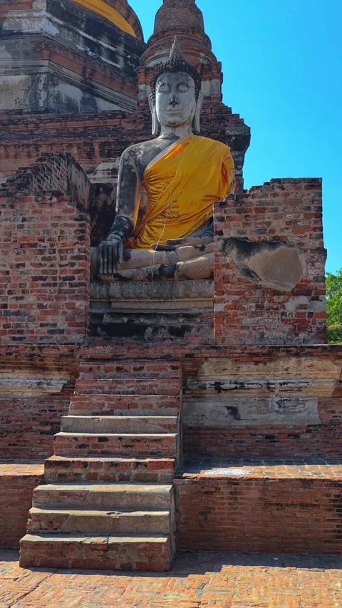 View of large Buddha statue draped in yellow robes in Ayutthaya, Thailand. Stock Footage 306949681