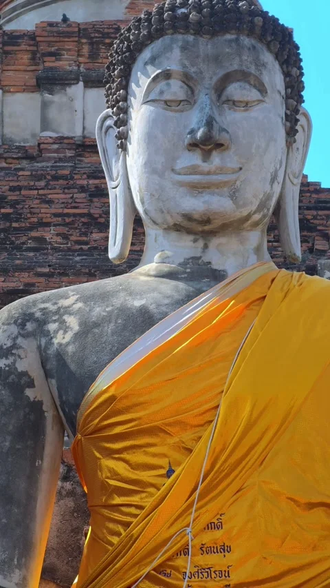 View of large Buddha statue draped in yellow robes in Ayutthaya, Thailand. Stock Footage 306950212