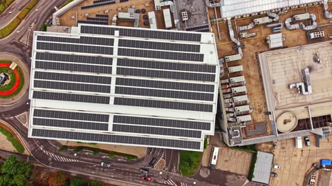 View of a large building with solar panels on the roof in an industrial area Stock Footage 341702920