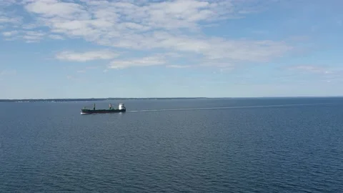 View of a large cargo ship sailing along the coast. Beautiful sky with clouds Stock Footage 170545902
