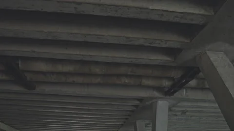 View of large grey concrete bridge structure from below Stock Footage 253126310