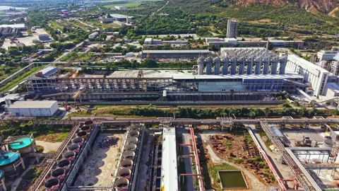 View of a large industrial complex with buildings, tanks, and pipes in a Stock Footage 341583169