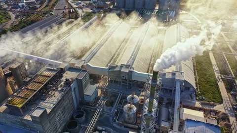View of a large industrial facility with smoke rising from chimneys located near Stock Footage 341030821